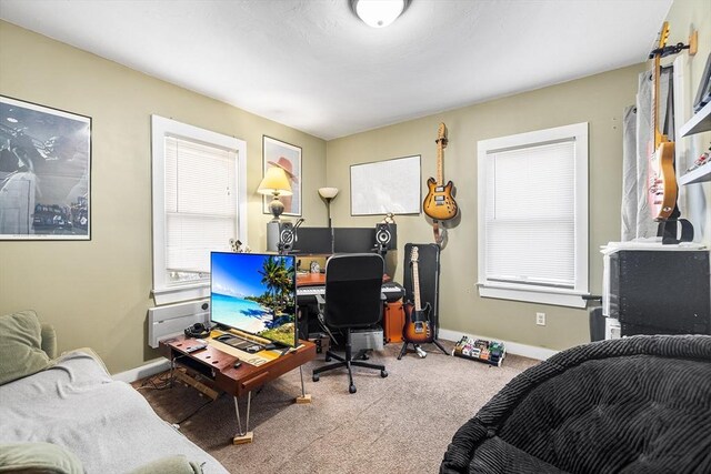 carpeted home office with baseboards