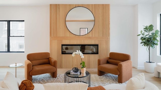 living area featuring a large fireplace and light wood-type flooring