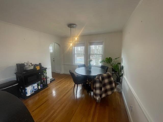 dining area with baseboards, wood finished floors, and a chandelier