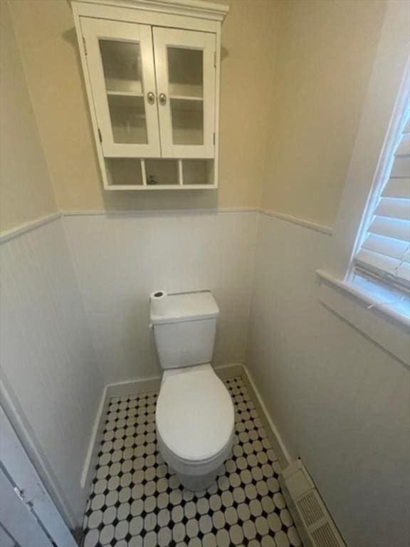 bathroom featuring visible vents, toilet, and wainscoting