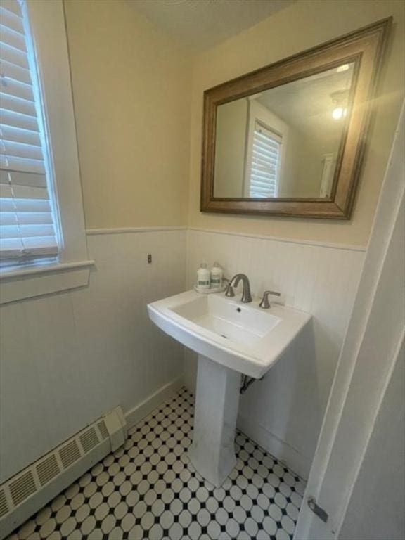 bathroom featuring a baseboard radiator and wainscoting