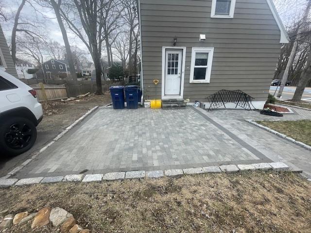 exterior space featuring entry steps and fence