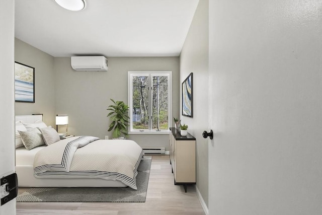 bedroom with wood finished floors, baseboards, a wall unit AC, and baseboard heating