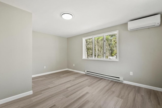 empty room with wood finished floors, baseboards, a wall unit AC, and baseboard heating
