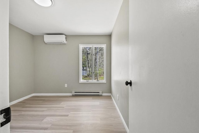 spare room featuring light wood-style floors, a wall unit AC, baseboards, and a baseboard radiator