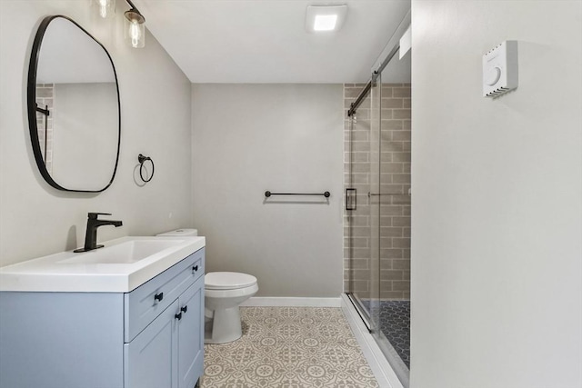 bathroom featuring vanity, toilet, baseboards, tiled shower, and tile patterned floors
