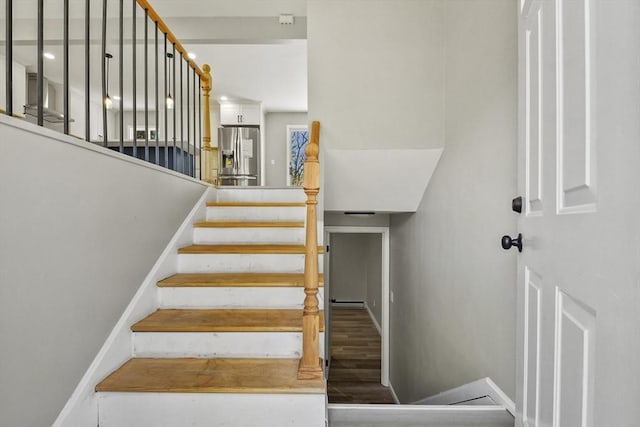 stairs featuring baseboards and wood finished floors