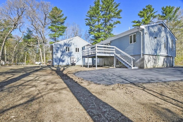 rear view of property with a deck and stairs