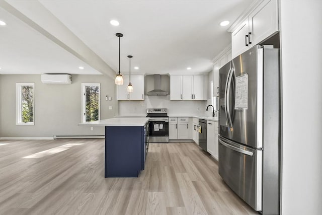 kitchen featuring wall chimney range hood, appliances with stainless steel finishes, a sink, a baseboard heating unit, and a wall mounted AC