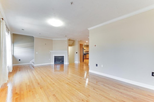 unfurnished living room with light wood-type flooring and crown molding