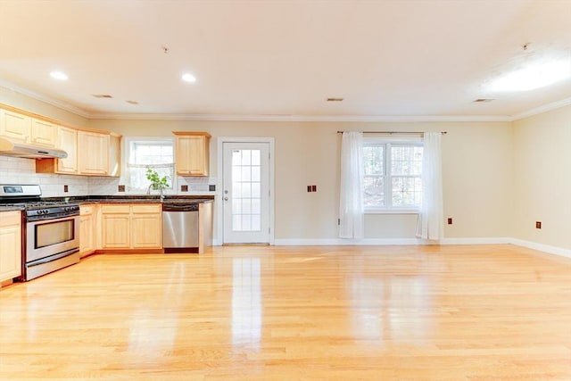 kitchen featuring appliances with stainless steel finishes, tasteful backsplash, light brown cabinetry, crown molding, and light wood-type flooring