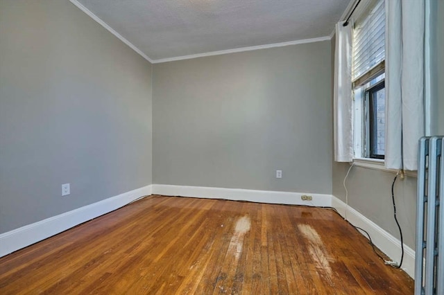 empty room featuring hardwood / wood-style floors, a healthy amount of sunlight, crown molding, and a textured ceiling