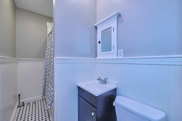 bathroom featuring tile patterned floors, vanity, and toilet