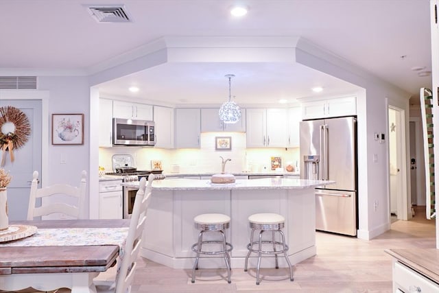 11 Cushing Pl Unit 106, Chelmsford, MA 01824 - kitchen with stainless steel appliances, a kitchen island, white cabinets, and recessed lighting