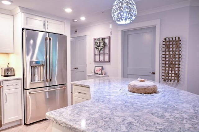 11 Cushing Pl Unit 106, Chelmsford, MA 01824 - kitchen featuring high quality fridge, recessed lighting, white cabinetry, light stone countertops, and ornamental molding