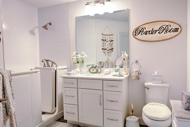 11 Cushing Pl Unit 106, Chelmsford, MA 01824 - bathroom featuring tiled shower, vanity, and toilet