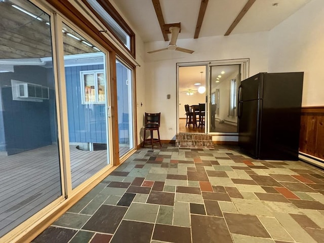 interior space featuring beam ceiling, a wall unit AC, and ceiling fan