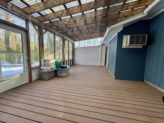 unfurnished sunroom with a wall unit AC and lofted ceiling