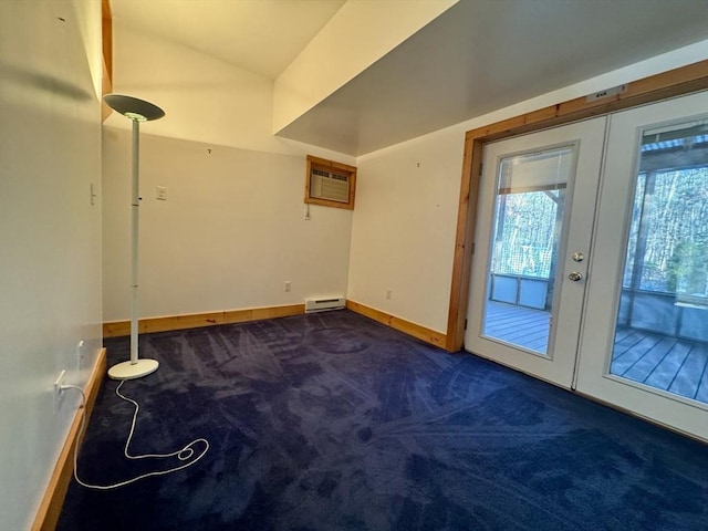 doorway to outside featuring a wall mounted air conditioner, dark carpet, a baseboard heating unit, and french doors