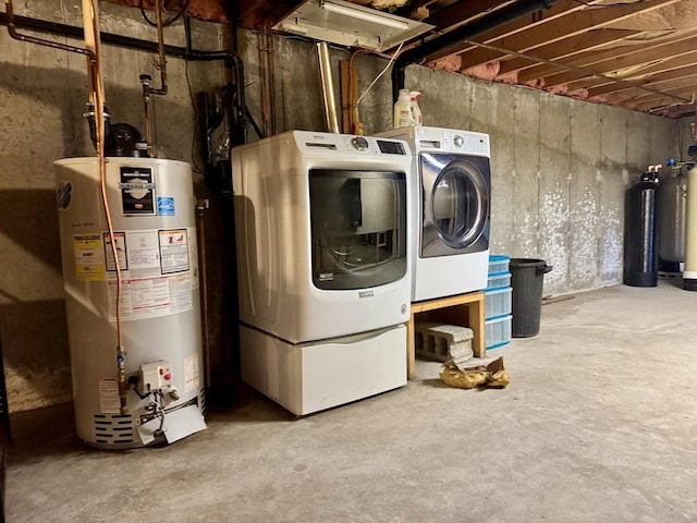 laundry room with washing machine and dryer and water heater