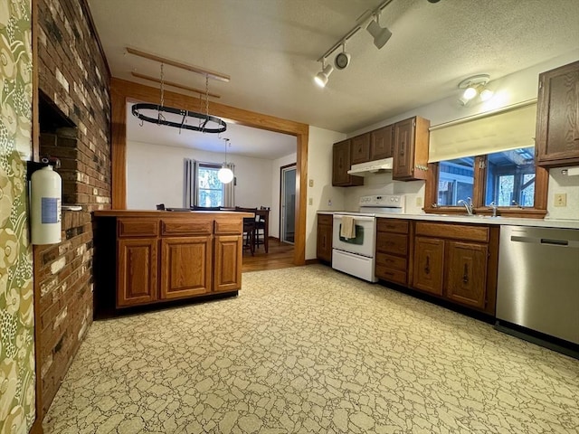 kitchen with sink, white electric range oven, hanging light fixtures, stainless steel dishwasher, and brick wall