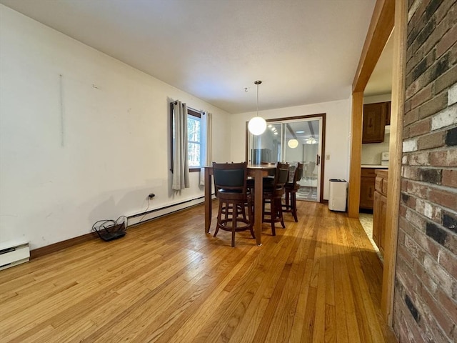 dining area featuring baseboard heating and light hardwood / wood-style flooring