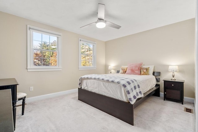 bedroom with visible vents, baseboards, ceiling fan, and light colored carpet