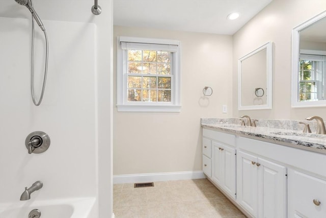 bathroom with double vanity, baseboards, visible vents, tile patterned flooring, and a sink