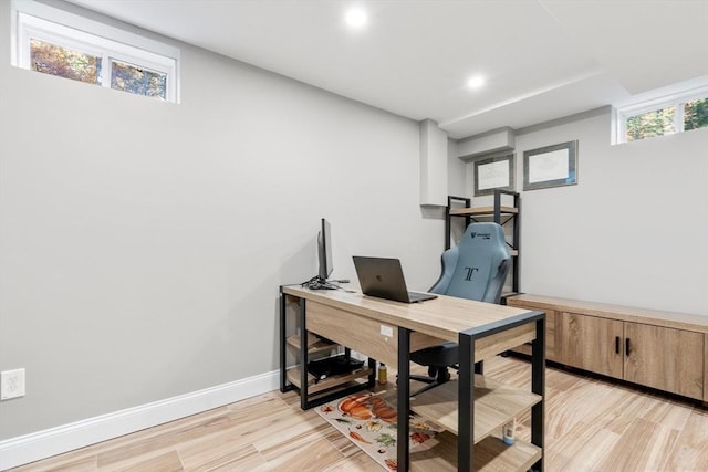 office area with light wood finished floors, recessed lighting, a wealth of natural light, and baseboards