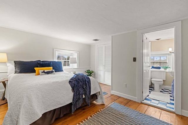 218 Washington St Unit 5, Marblehead, MA 01945 - bedroom with wood-type flooring, ensuite bathroom, baseboards, and a closet