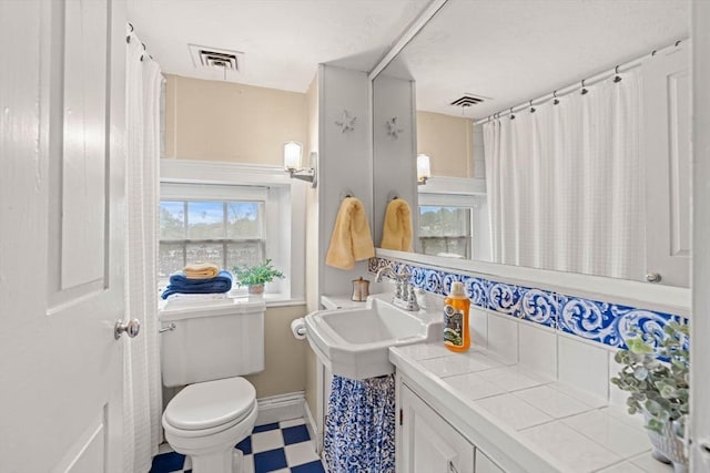 218 Washington St Unit 5, Marblehead, MA 01945 - bathroom with vanity, tile patterned floors, toilet, and baseboards