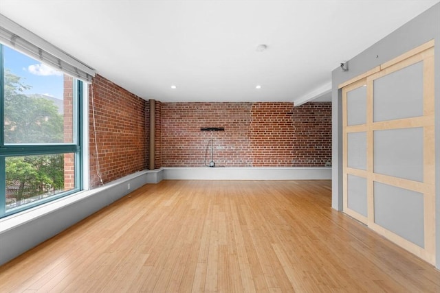 42 8th St Unit 1301, Boston, MA 02129 - empty room with brick wall, light wood-style flooring, and recessed lighting