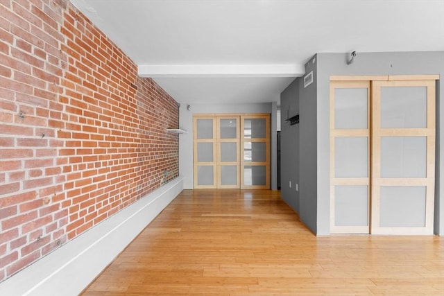 42 8th St Unit 1301, Boston, MA 02129 - hall with brick wall and light wood-style flooring