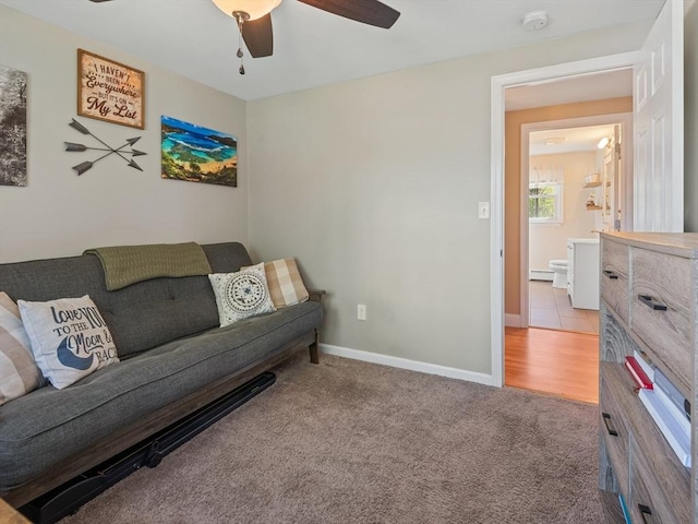 living area with baseboards, carpet, and a ceiling fan