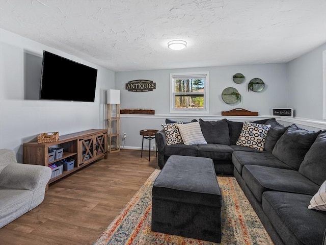 living room featuring a textured ceiling and wood finished floors
