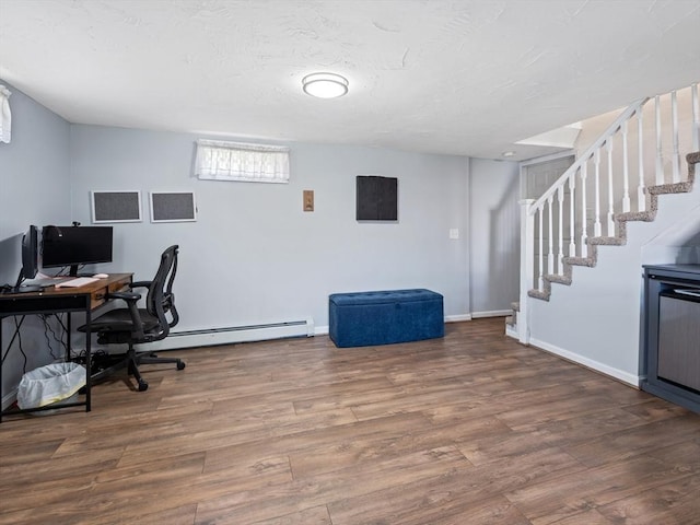 office featuring baseboards, a baseboard radiator, and wood finished floors