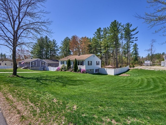 exterior space featuring a front lawn and fence