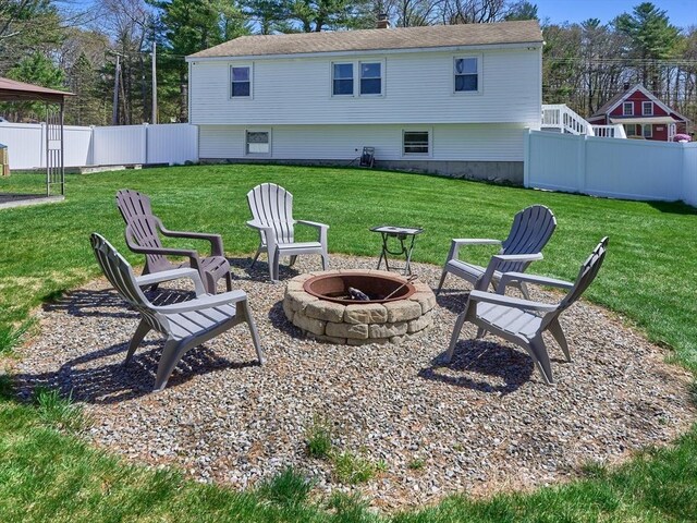 view of yard with a fenced backyard and a fire pit