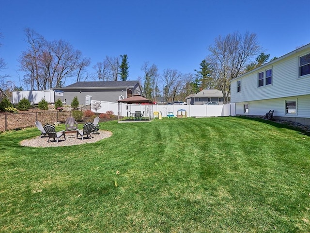 view of yard with a fire pit and fence