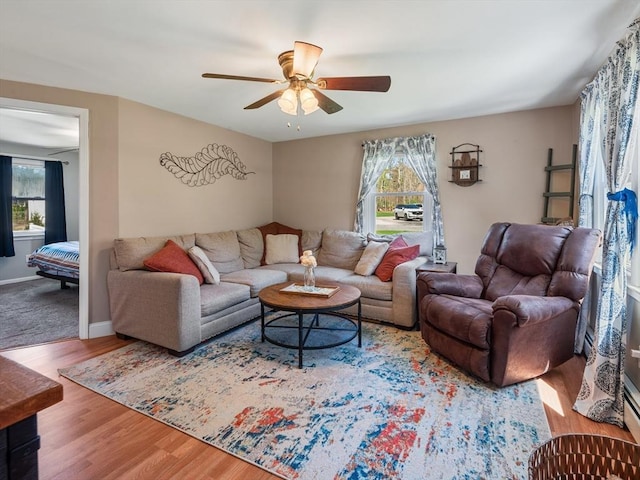 living area featuring plenty of natural light, a ceiling fan, and wood finished floors