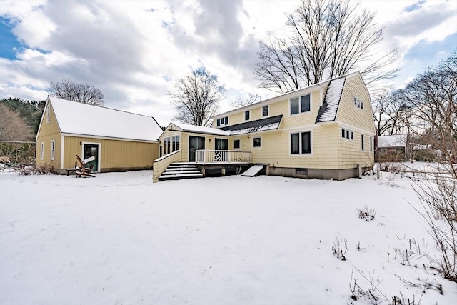 snow covered property featuring a deck