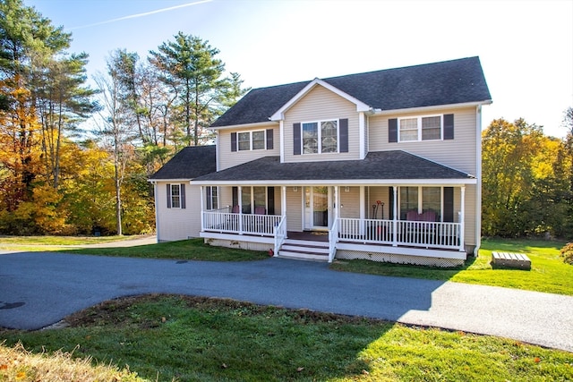 view of front facade with covered porch and a front lawn