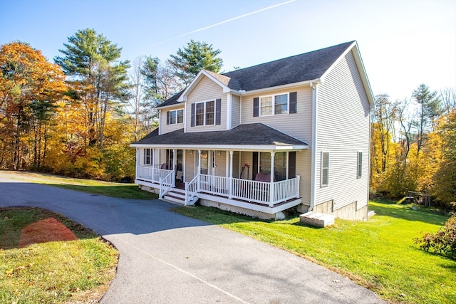 view of front of house featuring covered porch and a front lawn