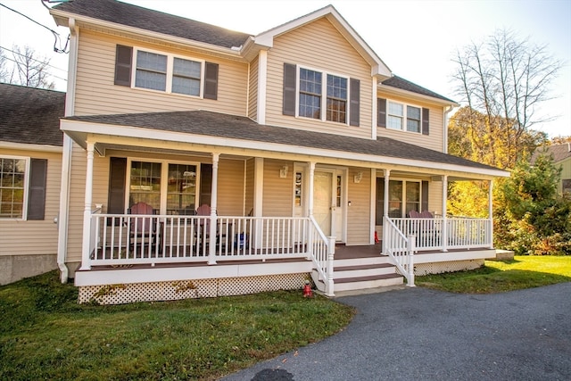 view of front of house with covered porch and a front yard