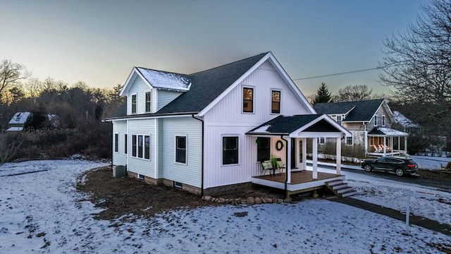 view of front of property with cooling unit and covered porch