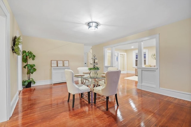 dining space with wood-type flooring