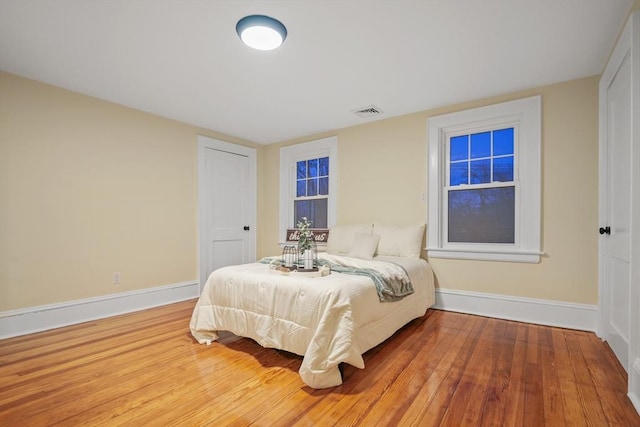 bedroom with hardwood / wood-style floors