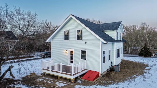 snow covered rear of property with cooling unit