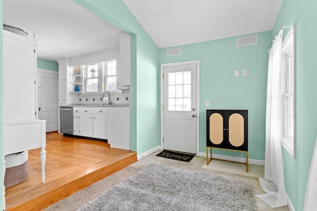 entryway with lofted ceiling and sink