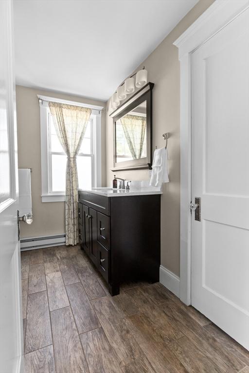 bathroom featuring a baseboard radiator and vanity